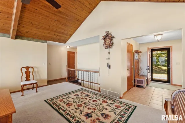 a view of an entryway with wooden floor and garden