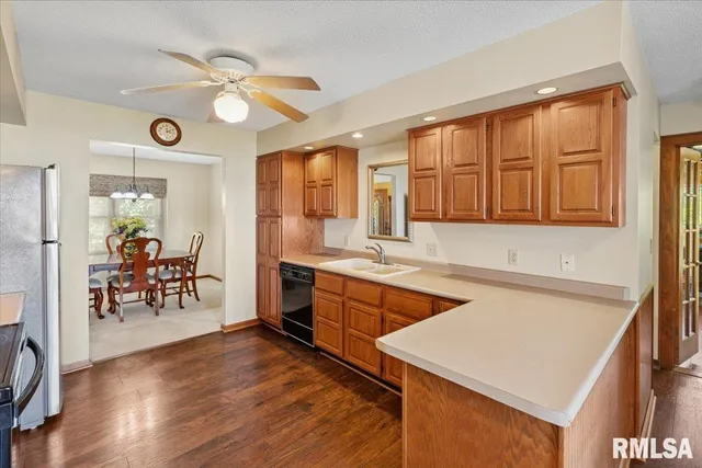 a kitchen with stainless steel appliances a refrigerator sink and stove