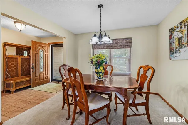 a view of a patio with dining table and chairs with wooden floor and fence