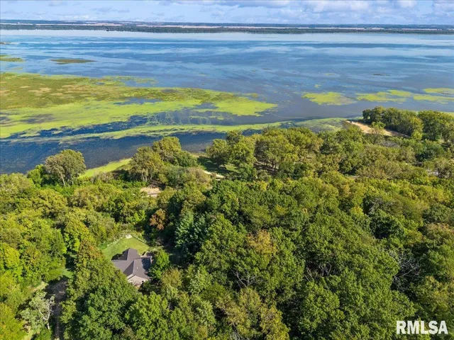a very nice looking living room with a large window and wooden floor