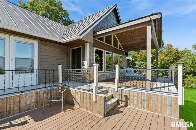 a view of house with a ocean view and wooden floor