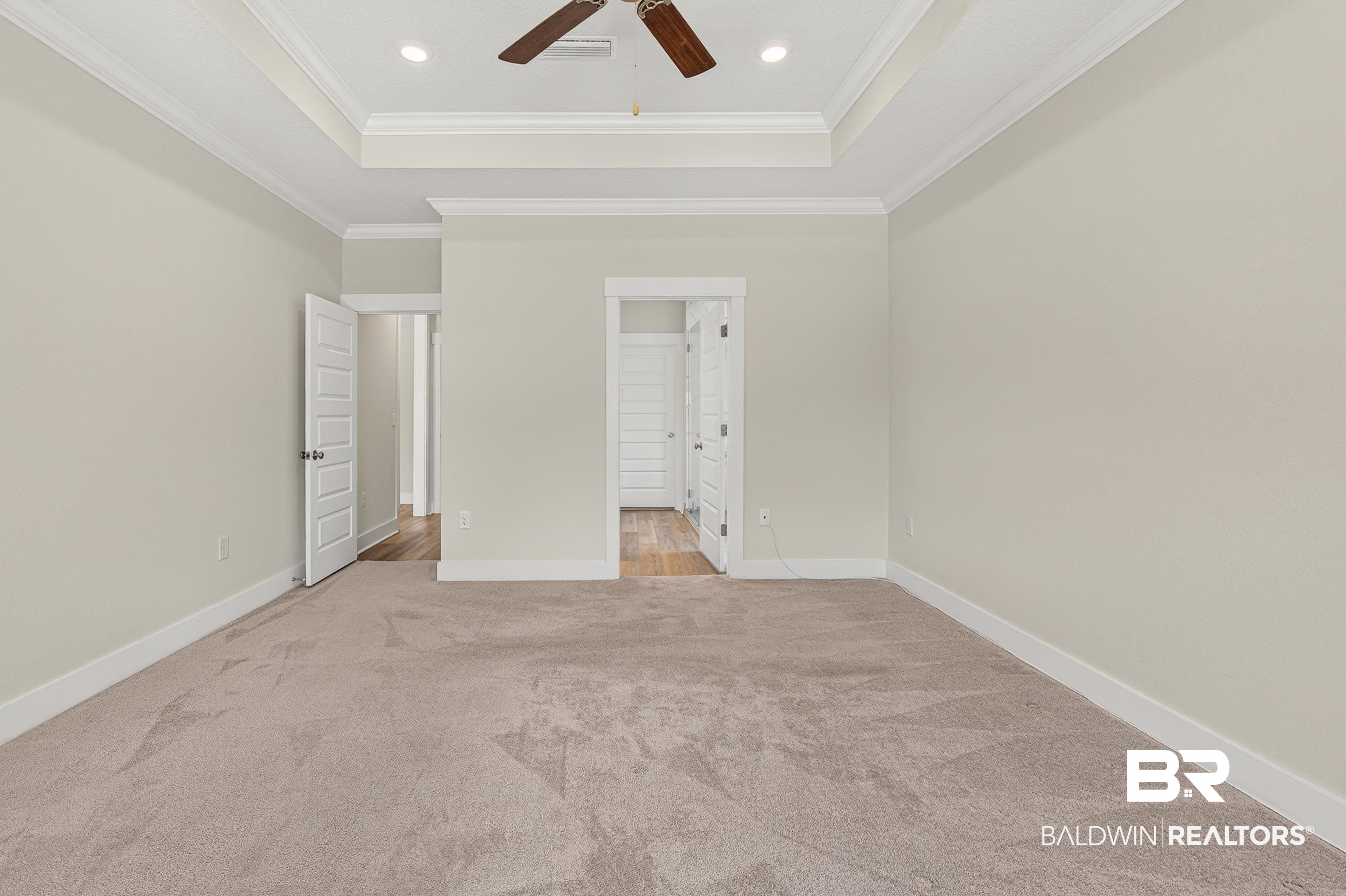 1724 Partridge Street Foley, AL 36535 - Photo 27 of 62 Spacious room featuring tray ceilings with recessed lighting, crown molding, and a ceiling fan