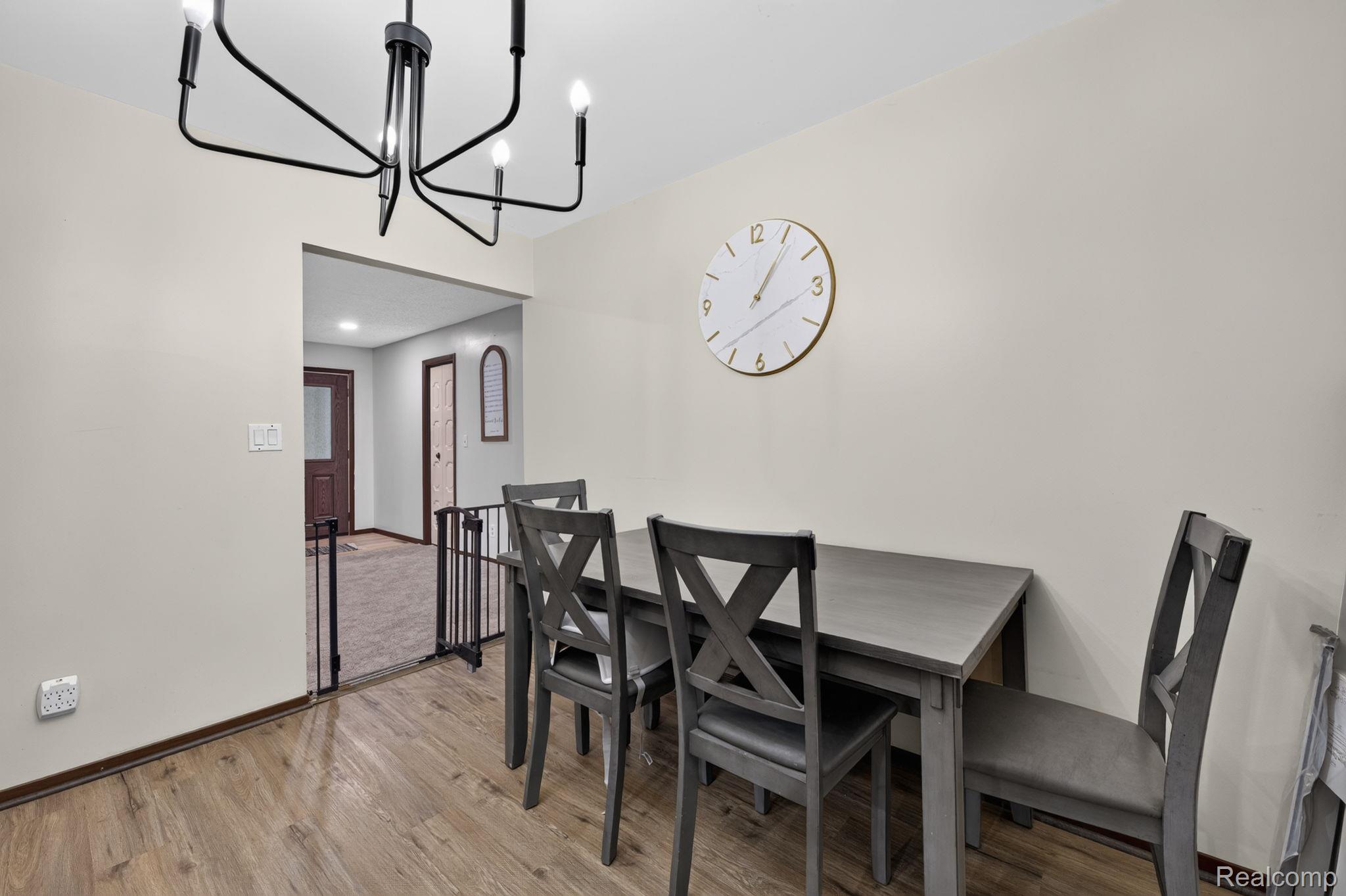 5330 Sheridan Road Saginaw, MI 48601 - Photo 14 of 50 Dining area featuring wood-finish flooring and a modern black chandelier