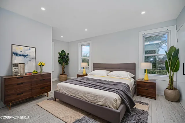 a bedroom with a bed and a potted plant