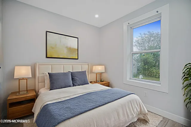 a bedroom with a bed and a lamp on dresser