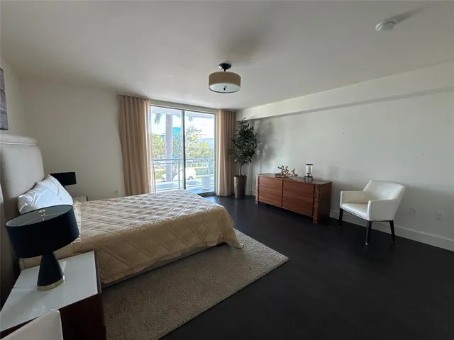 a bedroom with a bed chair and a window