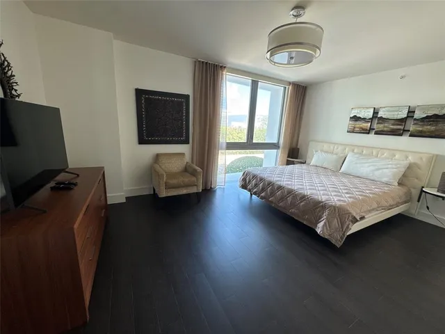 a bedroom with a bed window and couch