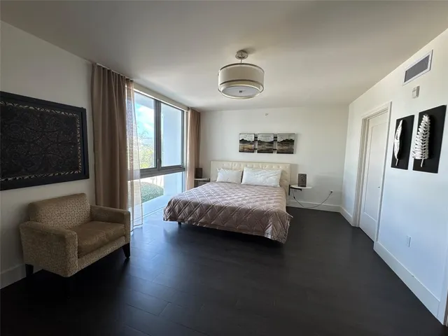 a spacious bedroom with a bed and a couch