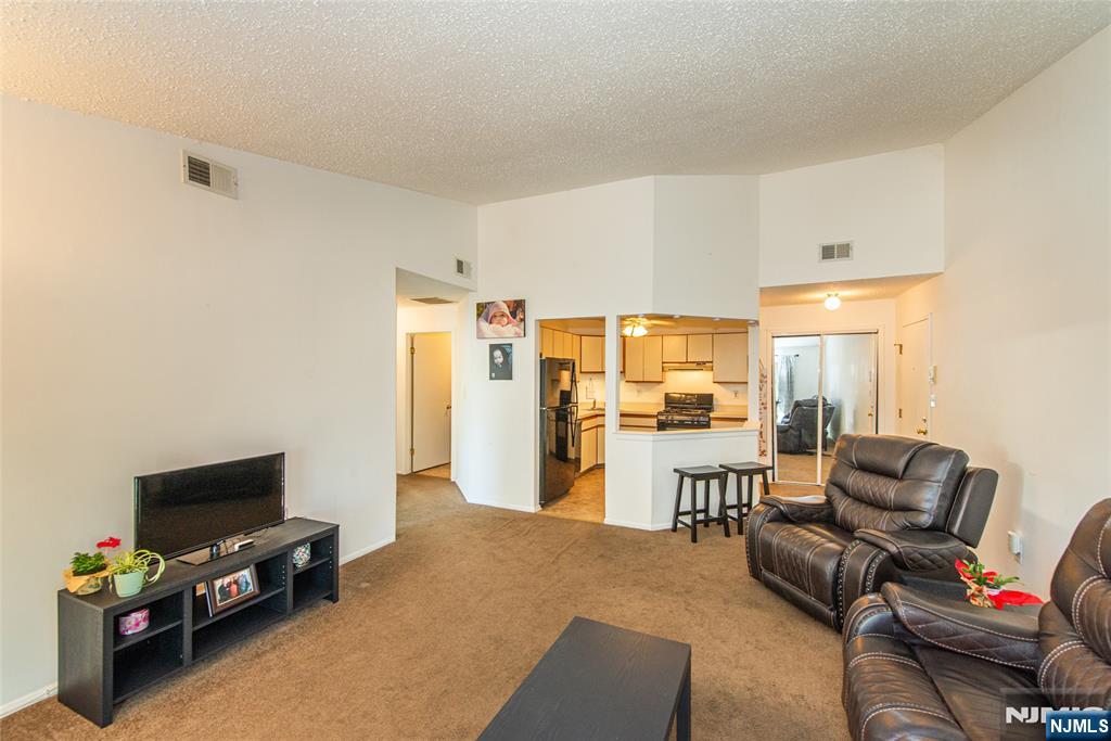 7 Drake Lane Roxbury Township, NJ 07852 - Photo 6 of 35 a living room with furniture and a flat screen tv