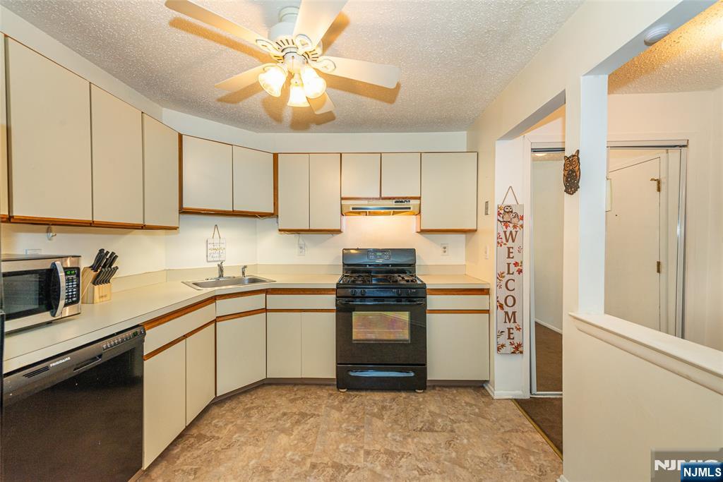 7 Drake Lane Roxbury Township, NJ 07852 - Photo 8 of 35 a kitchen with stainless steel appliances granite countertop a refrigerator a sink dishwasher a stove with white cabinets