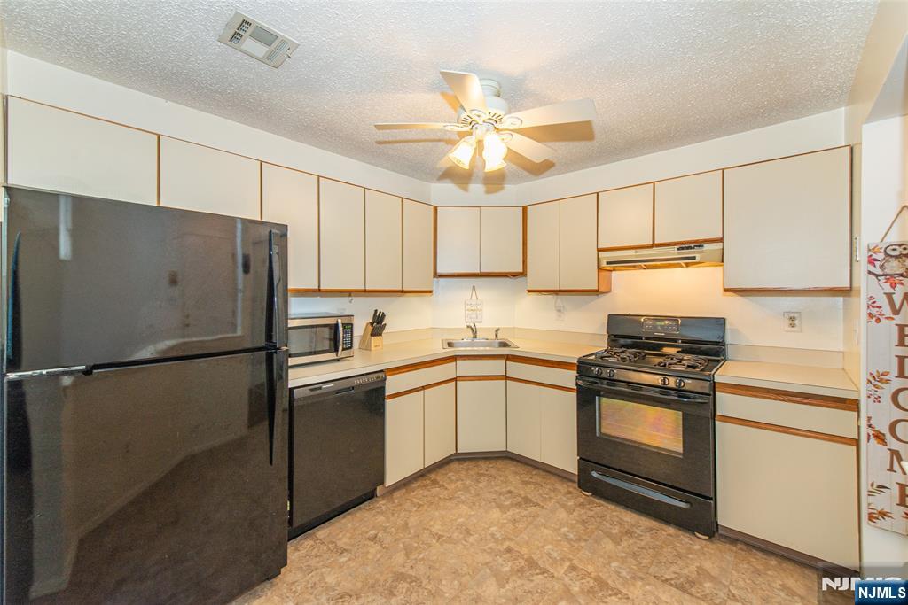 7 Drake Lane Roxbury Township, NJ 07852 - Photo 9 of 35 a kitchen with stainless steel appliances granite countertop white refrigerator stove a sink and dishwasher