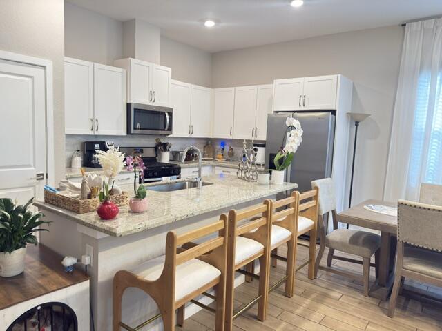 19696 Weathervane Way Loxahatchee, FL 33470 - Photo 6 of 39 a kitchen with stainless steel appliances granite countertop a sink and a refrigerator