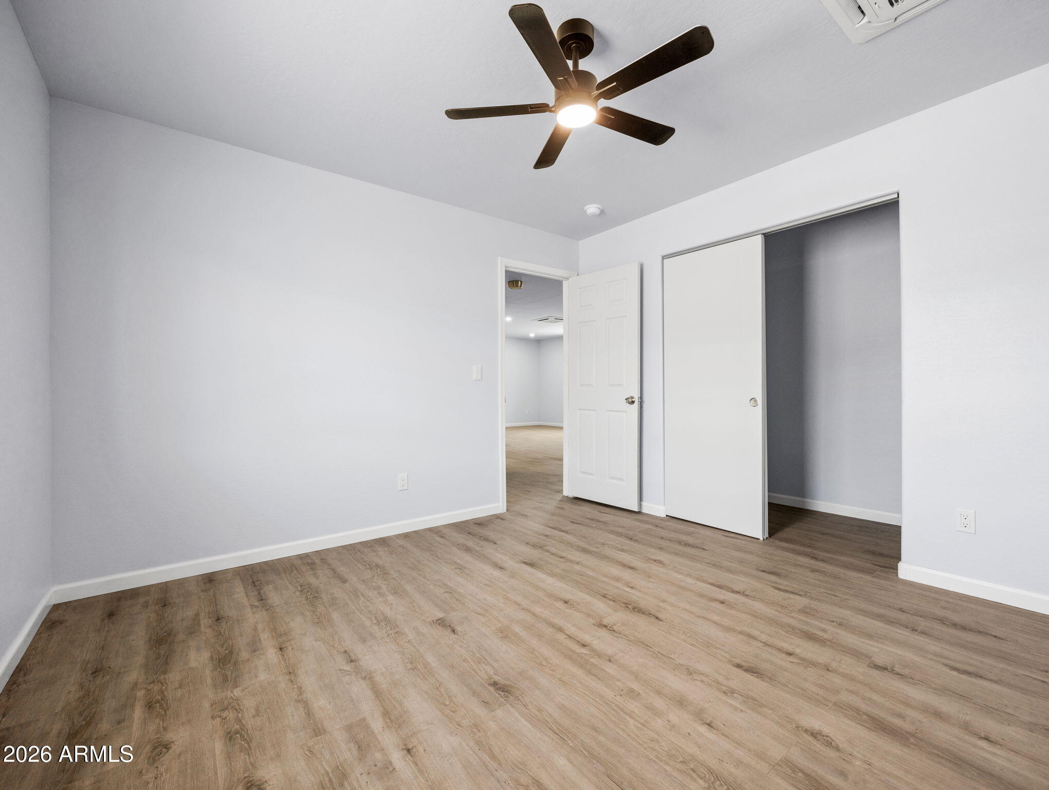 18278 Frontier Road Peeples Valley, AZ 86332 - Photo 23 of 31 an empty room with wooden floor and a ceiling fan