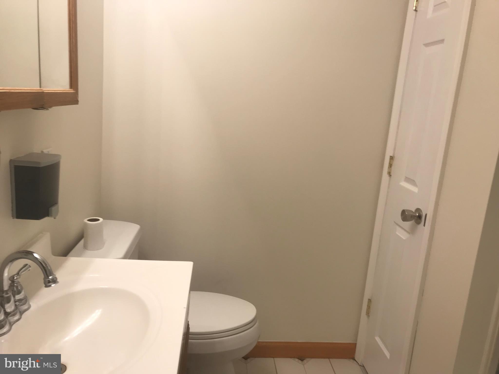 297 Townsend Road Essex, MD 21221 - Photo 12 of 39 Main floor bathroom with linen closet