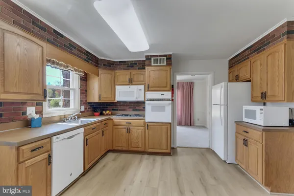 a kitchen with a sink and a fireplace
