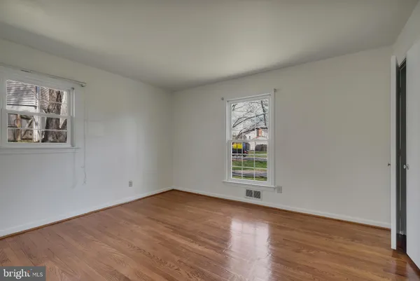 a view of an empty room and wooden floor