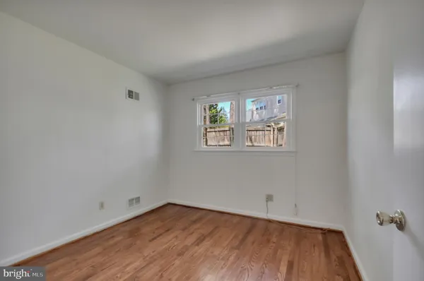 an empty room with windows and stairs