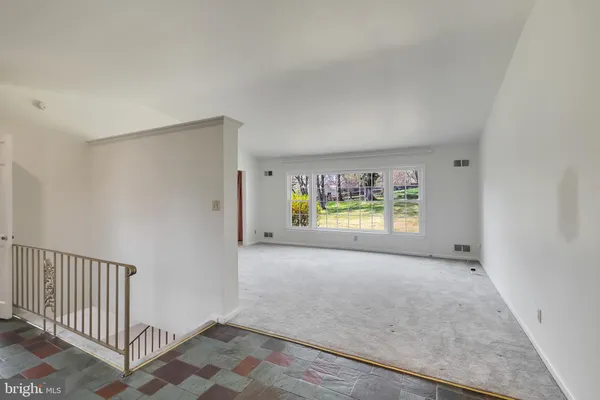 a view of a big room with windows and closet