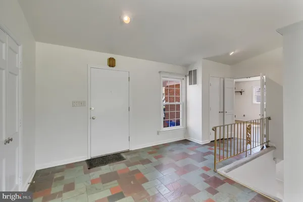 an empty room with windows and closet