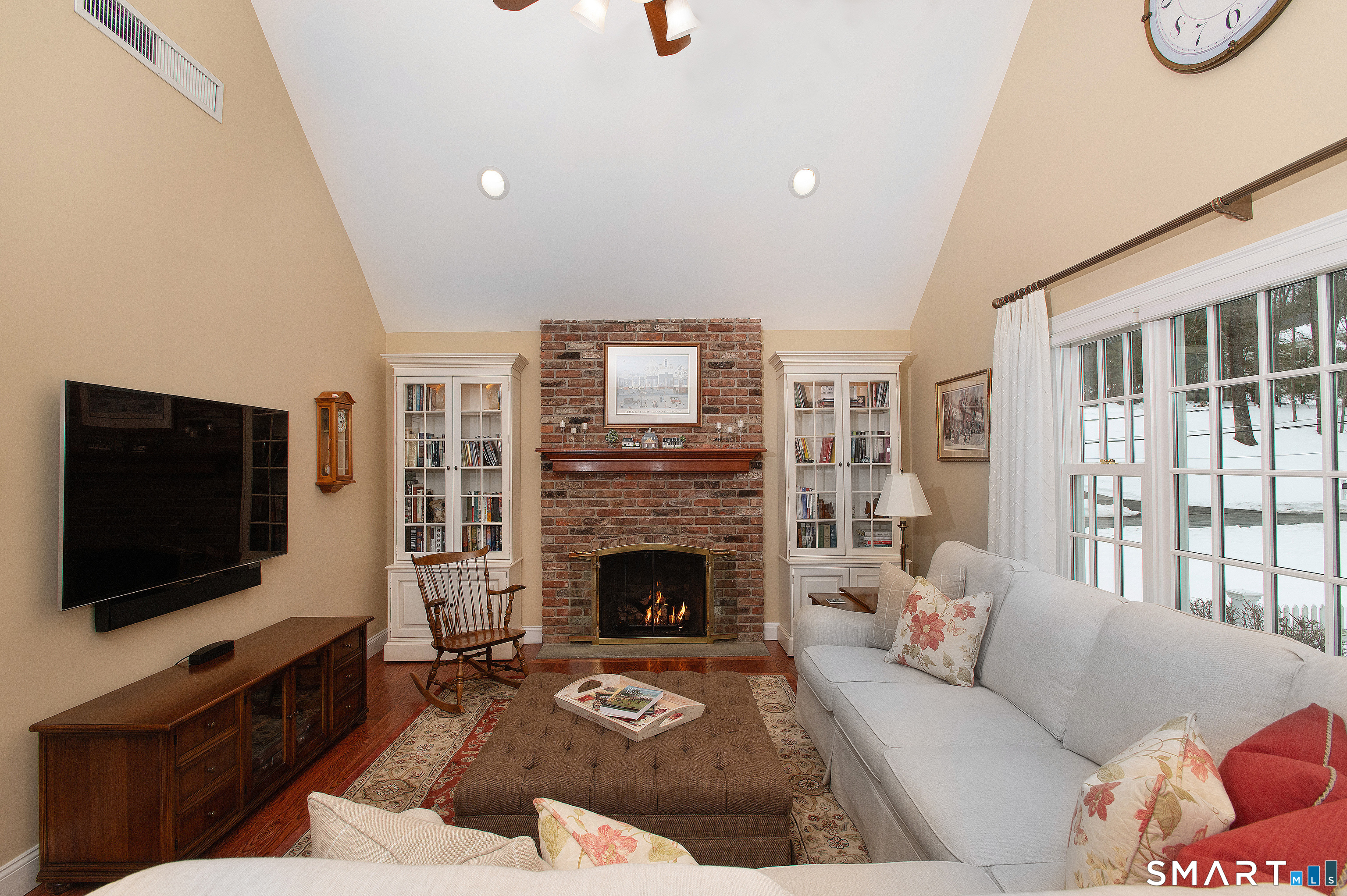 15 Twopence Road Ridgefield, CT 06877 - Photo 17 of 42 a living room with furniture a flat screen tv and a fireplace