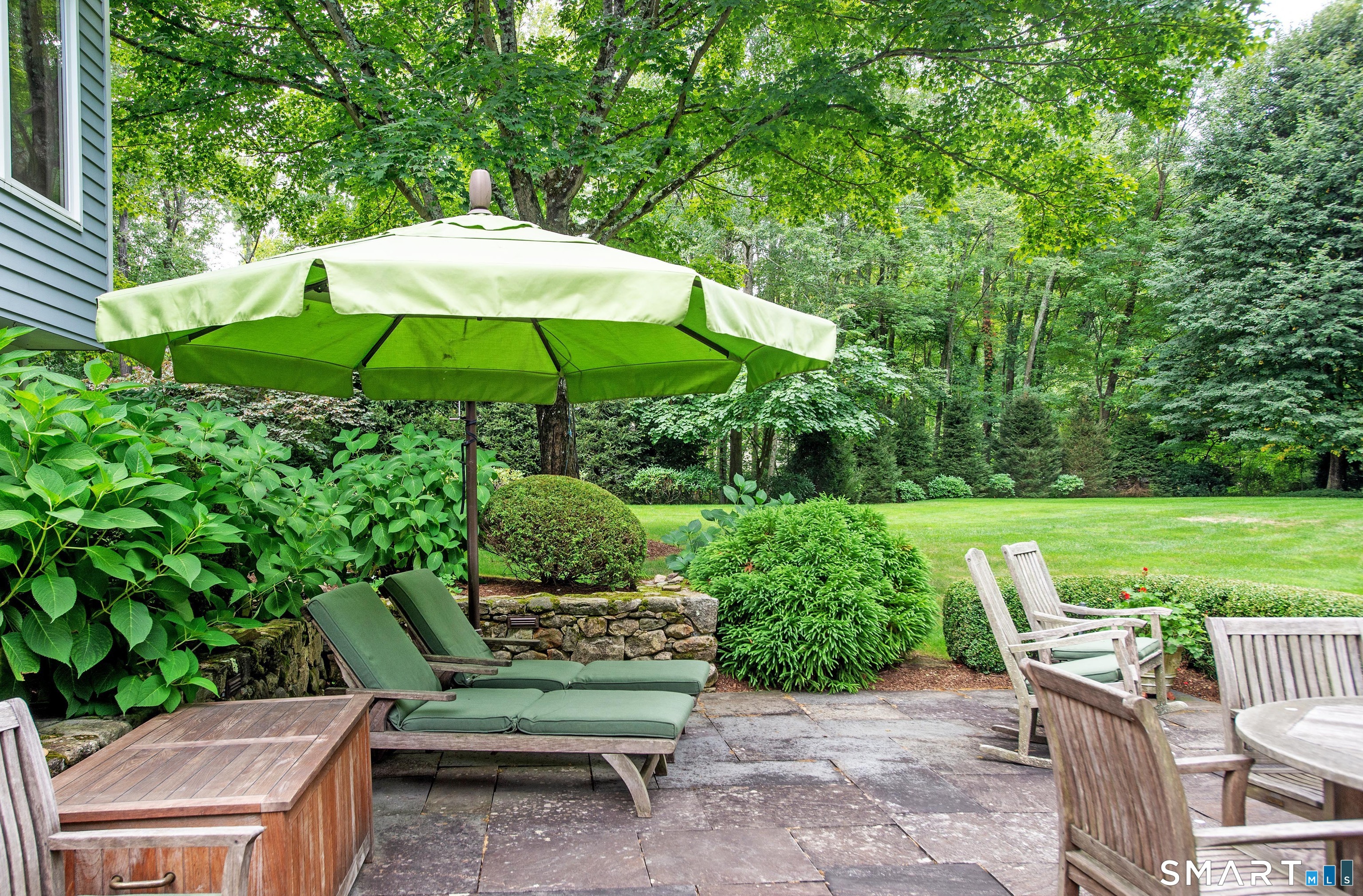15 Twopence Road Ridgefield, CT 06877 - Photo 7 of 42 a view of a chair and table in the garden