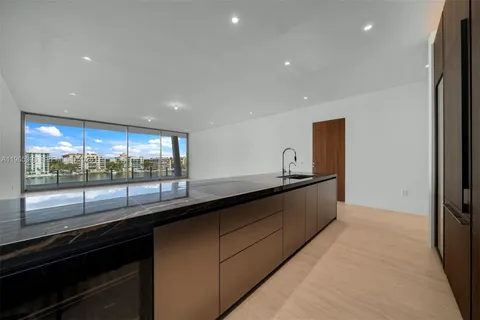 a large kitchen with stainless steel appliances a large counter top
