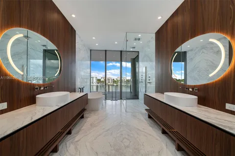 a spacious bathroom with a double vanity sink and a mirror