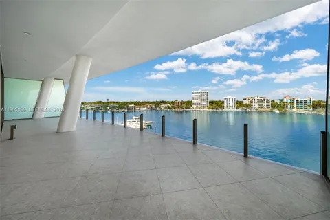 a view of a lake with a table and chairs