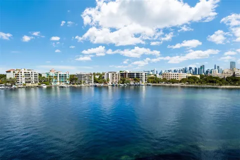 a view of a lake with boats and trees in the background