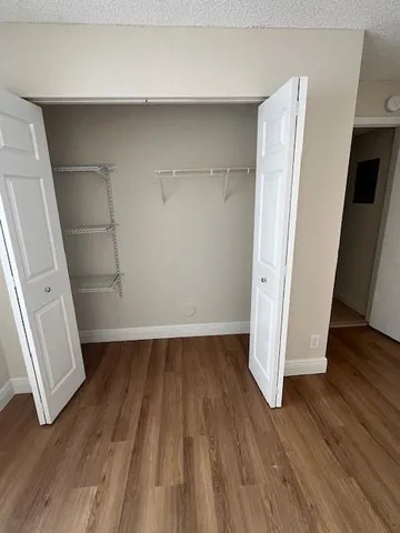 an empty room with wooden floor and gate
