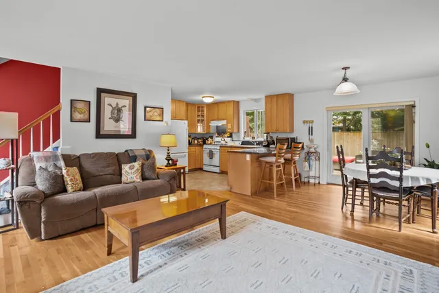 a living room with furniture wooden floor and a table