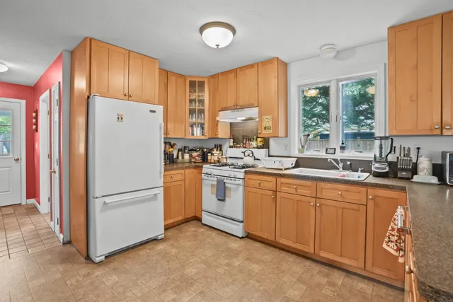 a kitchen with appliances a sink and a counter top space