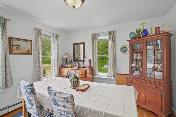 a view of a dining room with furniture a chandelier and wooden floor