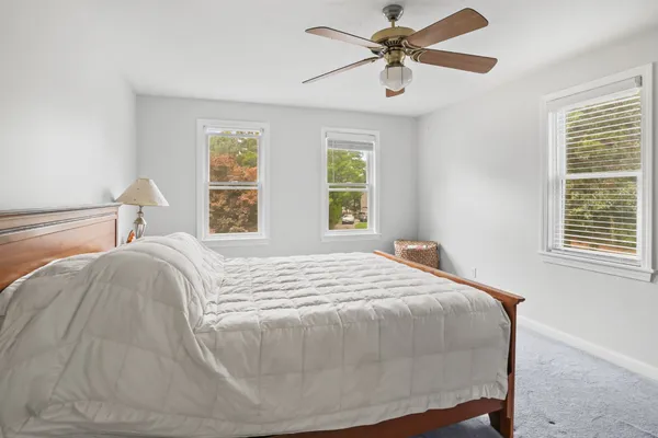 a bedroom with a bed and window