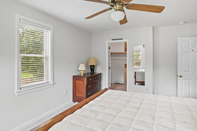 a spacious bedroom with a bed and a chandelier