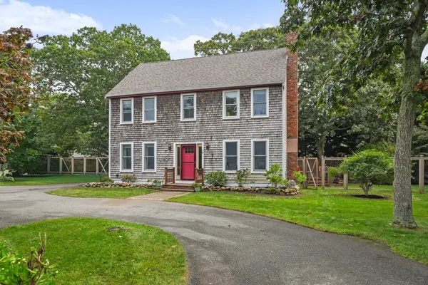 a front view of house with yard and green space