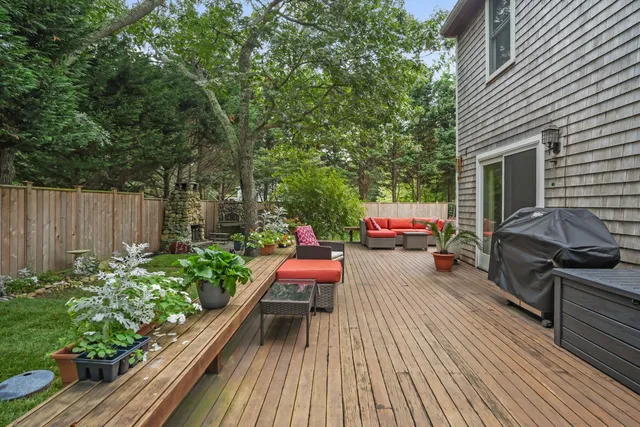 a view of a chairs and table on the wooden deck