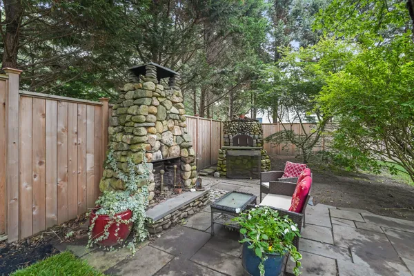 a backyard with hardwood wall and outdoor seating