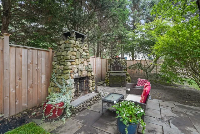 a backyard with hardwood wall and outdoor seating