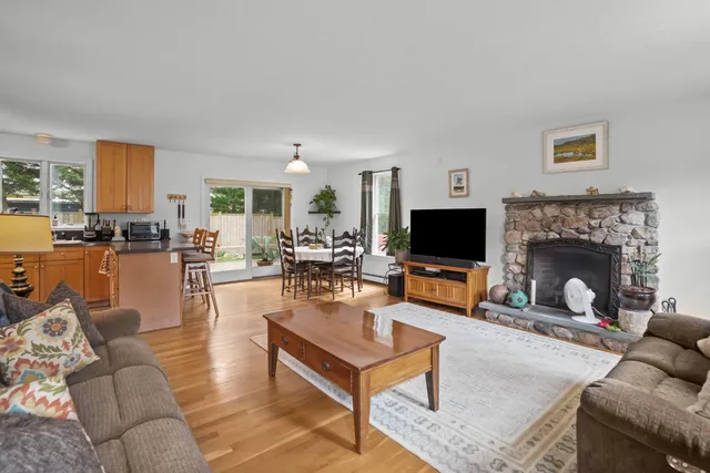 a living room with furniture a flat screen tv and a fireplace