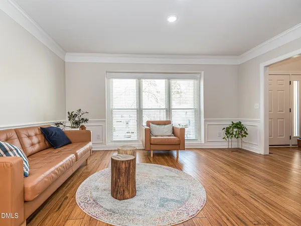 a living room with furniture and a floor to ceiling window