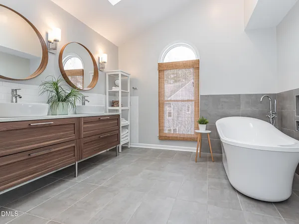 a bathroom with a double vanity sink and a mirror
