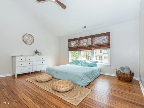 a bedroom with a bed and wooden floor