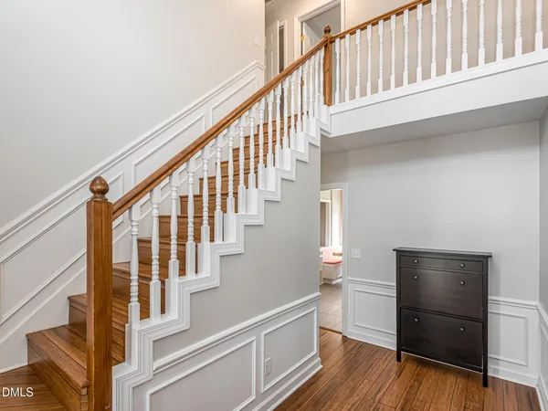 a view of entryway with wooden floor and front door