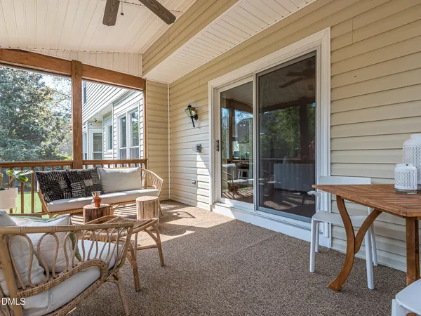 a balcony with furniture and large windows