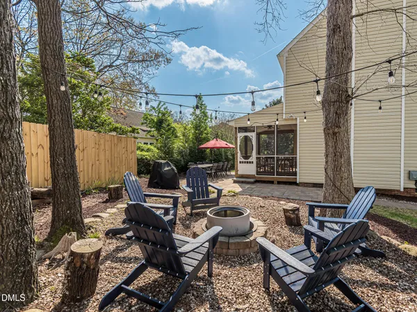 a view of a house with backyard and sitting area