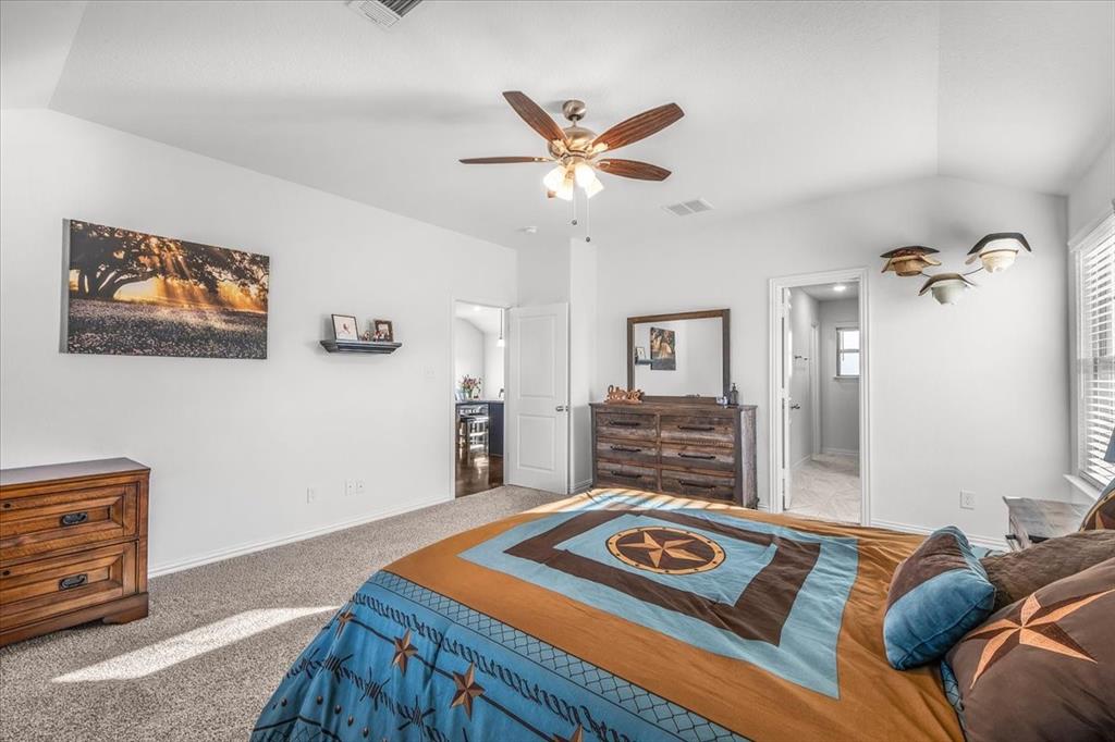 3797 Pine Road Poolville, TX 76487 - Photo 11 of 22 a bedroom with furniture and a chandelier