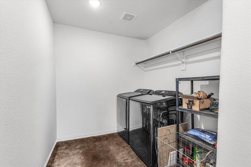 3797 Pine Road Poolville, TX 76487 - Photo 17 of 22 a view of storage and utility room with washer and dryer