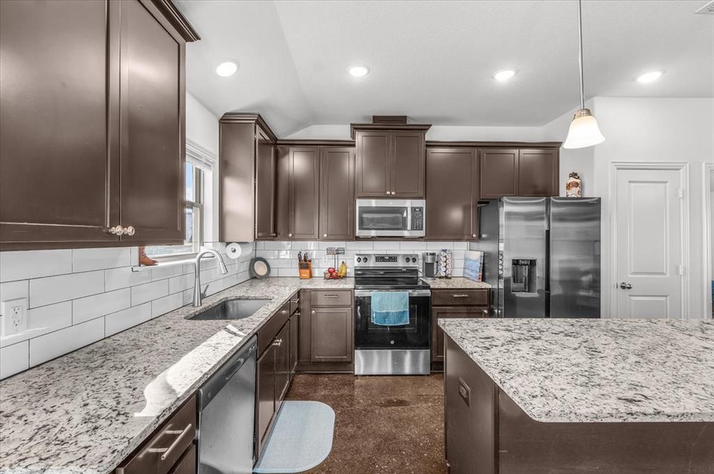 3797 Pine Road Poolville, TX 76487 - Photo 7 of 22 a kitchen with lots of counter space and stainless steel appliances