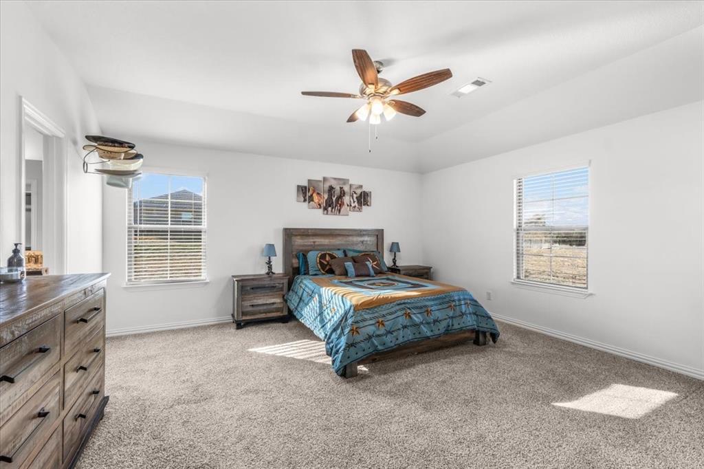 3797 Pine Road Poolville, TX 76487 - Photo 9 of 22 a bedroom with a bed and a window